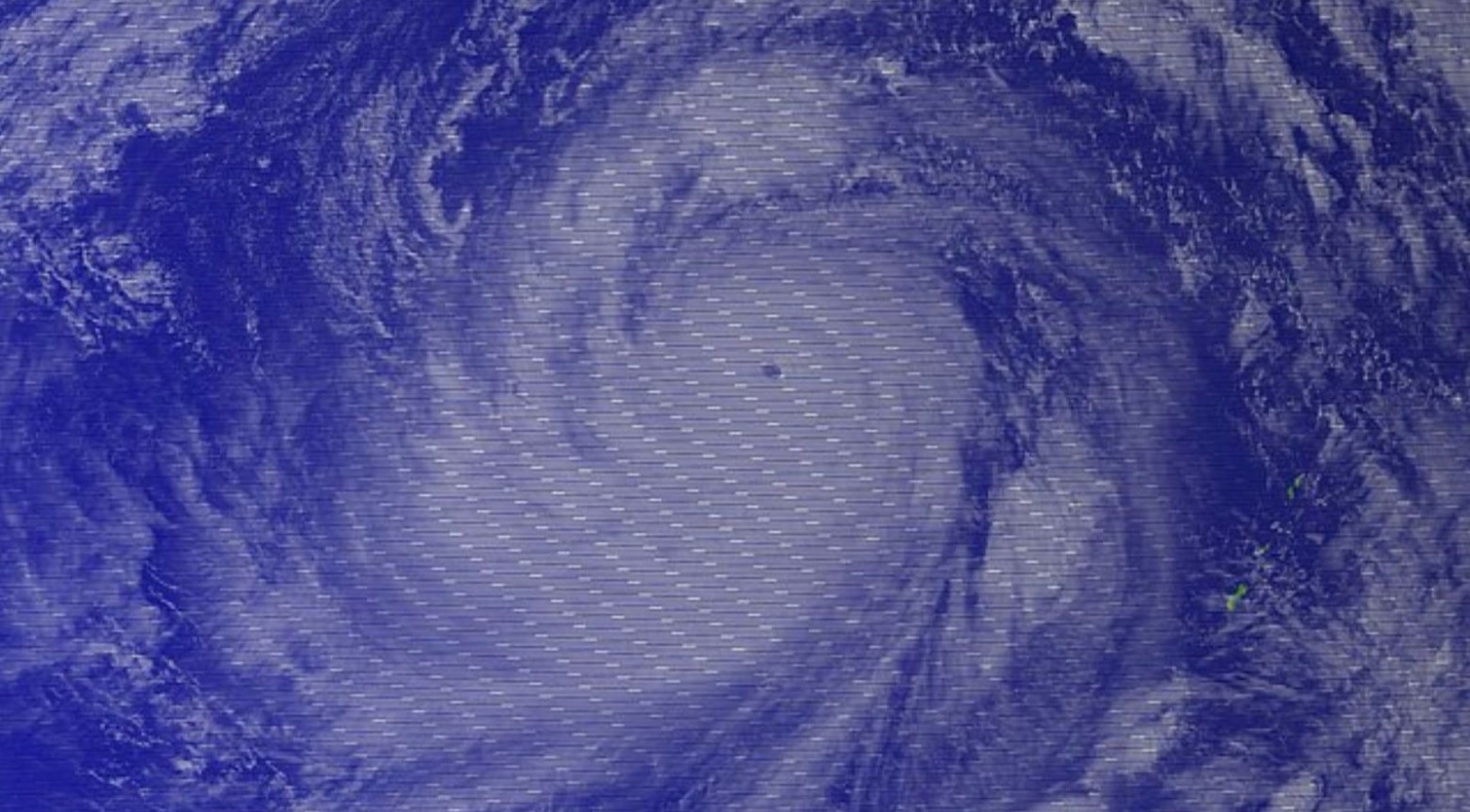 A blue image from a satellite following Typhoon Tip.