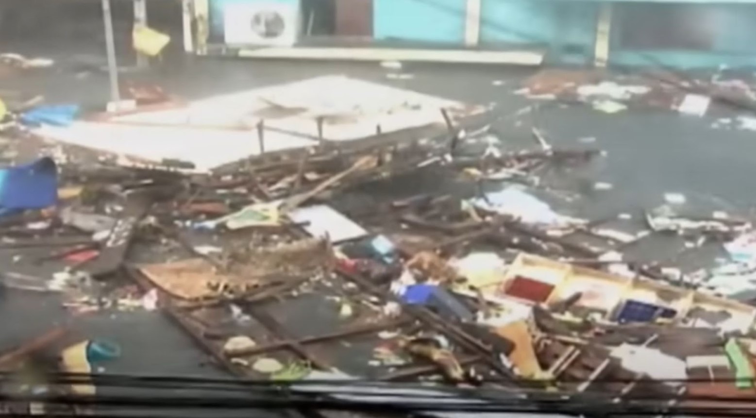Debris floating down a road due to a typhoon.