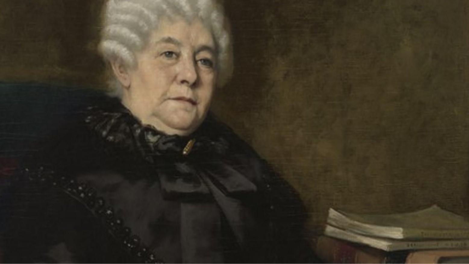 A painting of Elizabeth Cady Stanton. She has white hair in curls and is wearing a black dress. She is sitting next to a table that has two books on top.